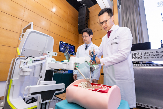 Dr Kenny Kwan Yat-hong (right) demonstrates the robot-assisted spine surgery.  
 